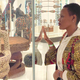 A woman stares at a statue